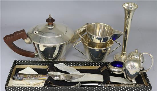 An Art Deco silver three piece tea set, a silver cruet stand, a carving set and a vase